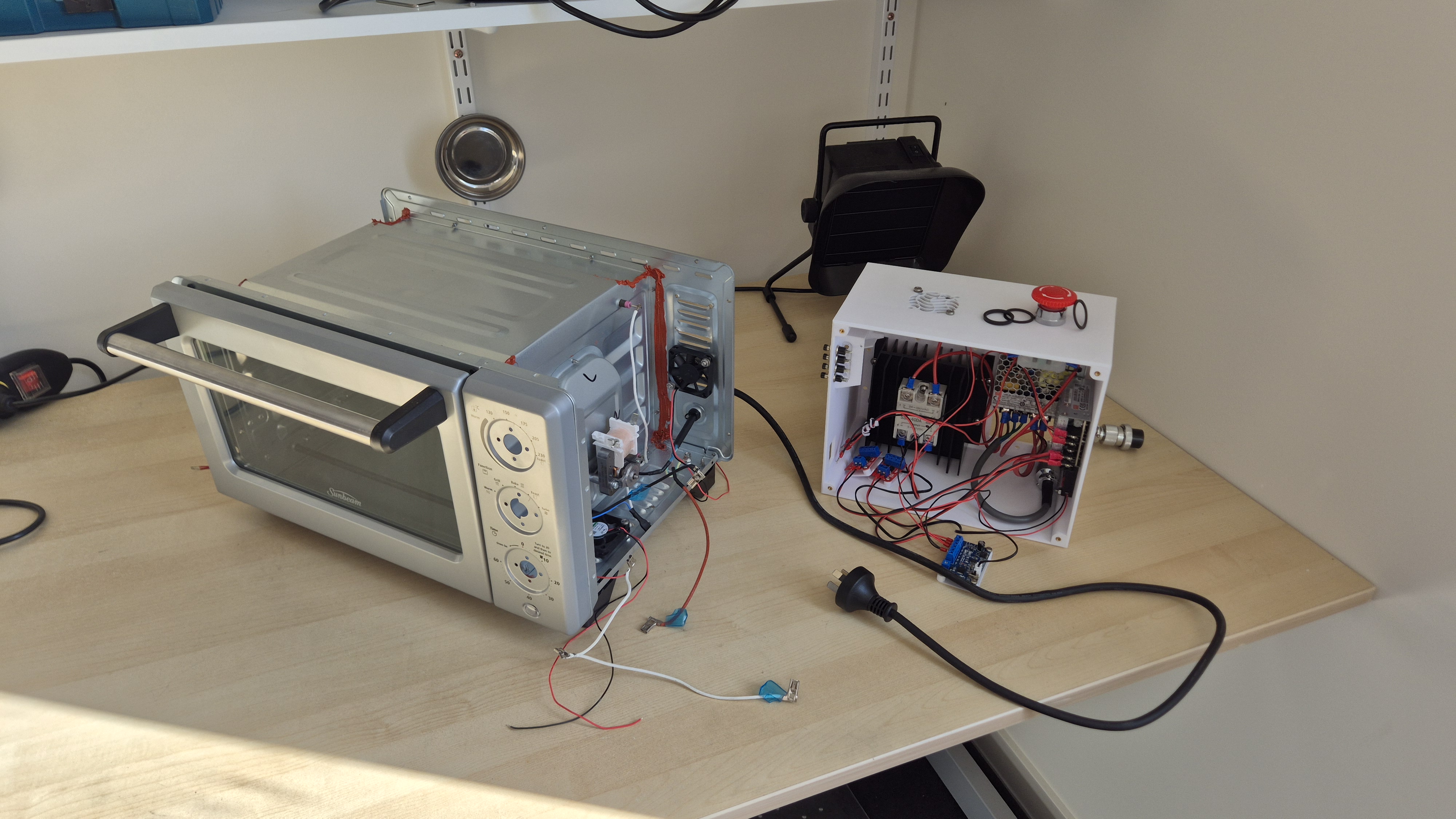 Reflow oven on bench with electronics apart